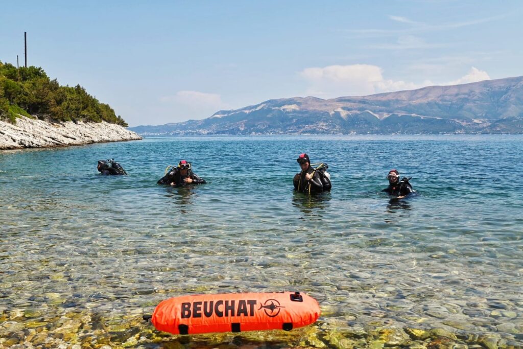 Scuba divers preparing for a dive in Dhërmi